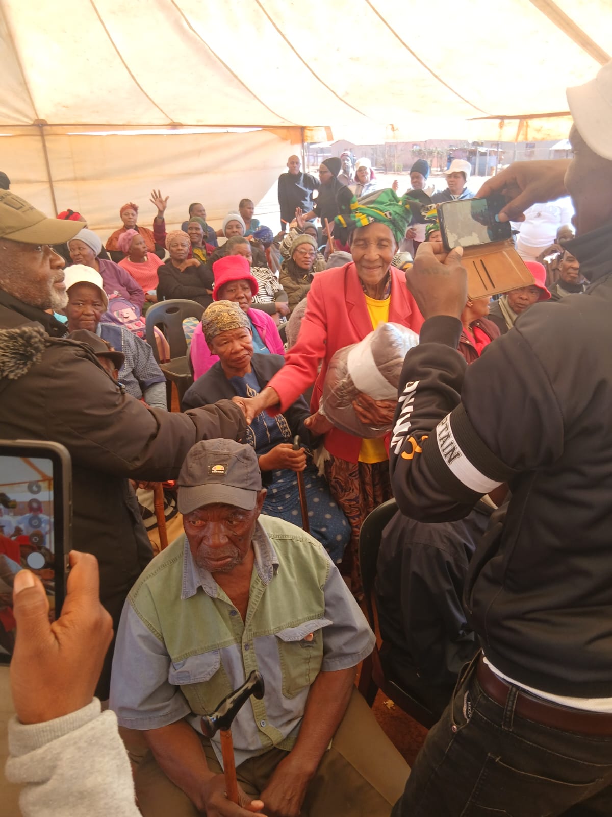 An elderly community member receiving support during the Nelson Mandela Day event
