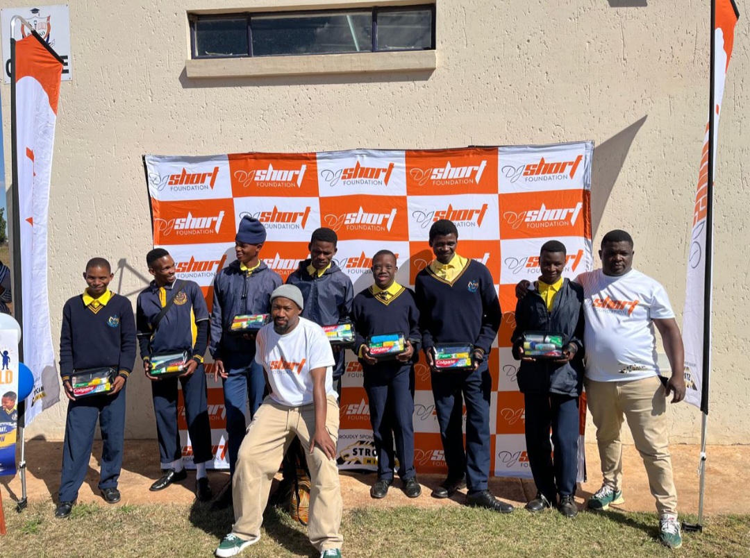 Learners proudly displaying their educational care packs