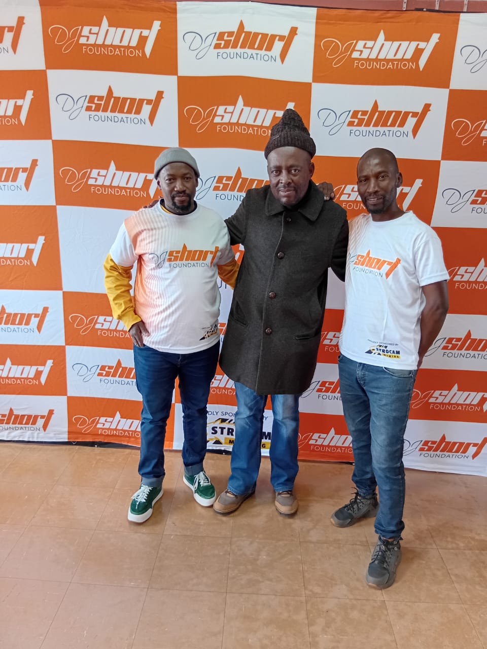 DJ Short Foundation founders with a community elder at the uniform handover