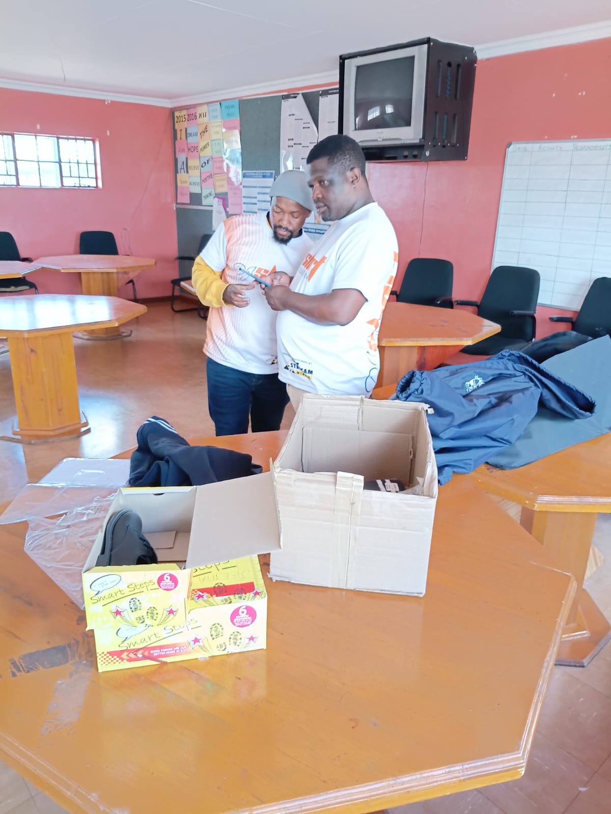 Foundation team preparing uniforms and shoes for distribution