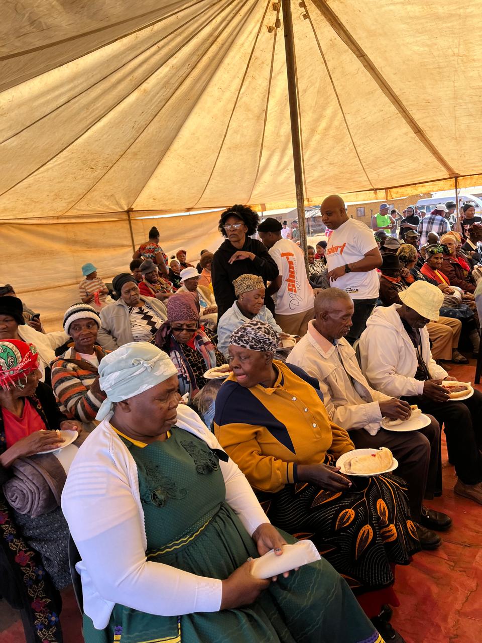 Elderly guests enjoying meals during the Nelson Mandela Day celebration
