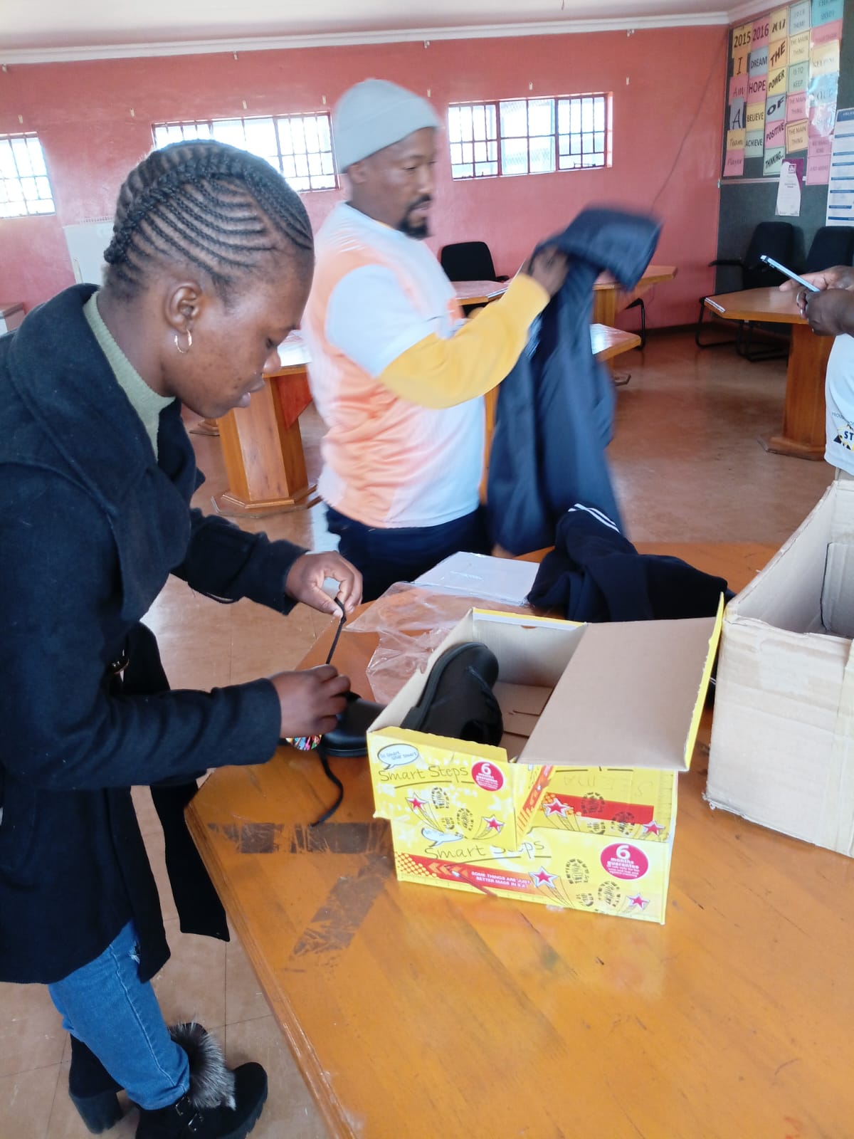 Sorting school shoes and uniforms ahead of the handover to learners