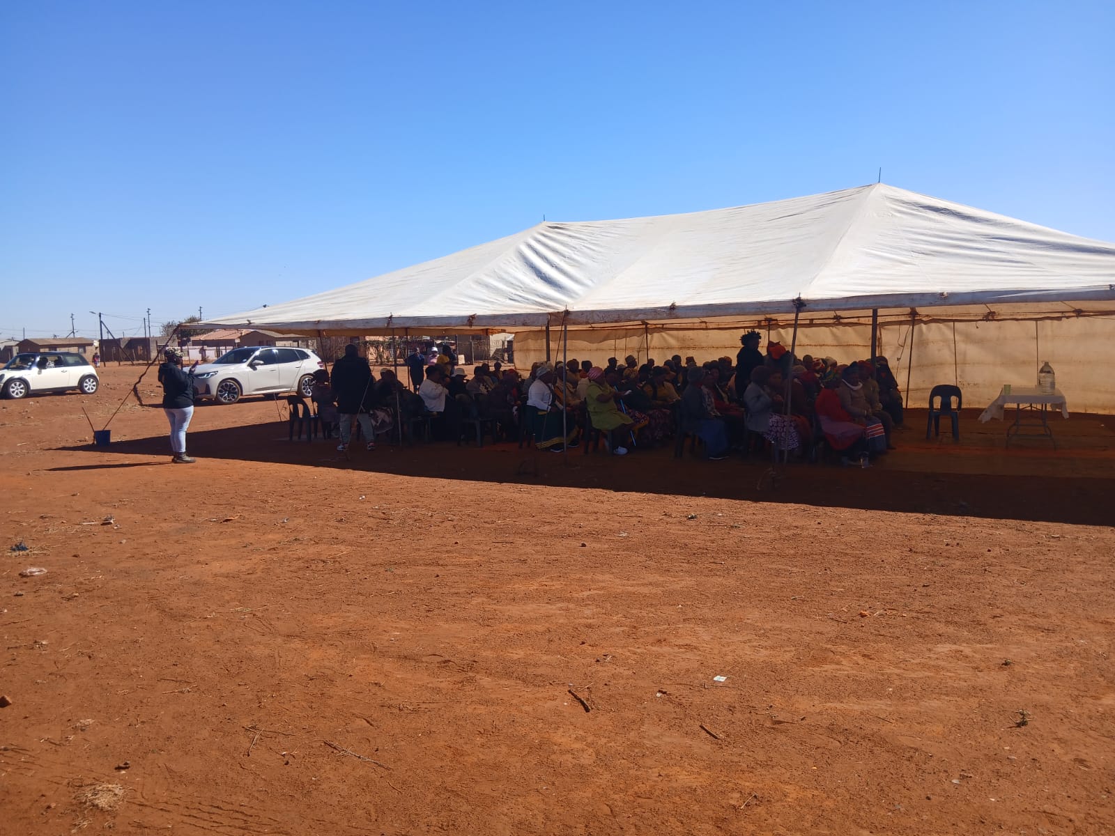 Community members gathered beneath the marquee in Khutsong South Ext 5